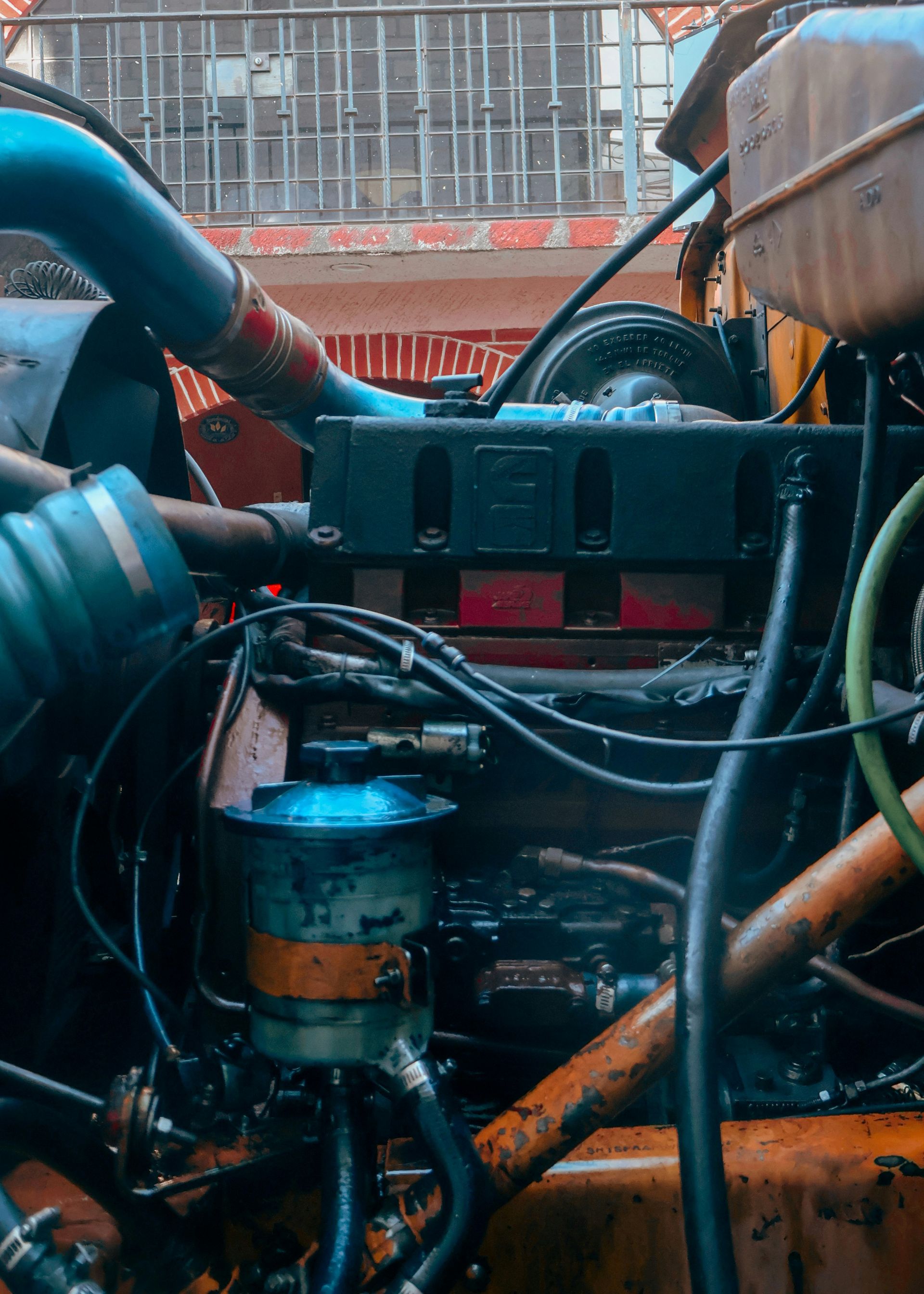 Close-up of a complex truck engine with pipes and wires.